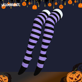 Purple and black striped thigh-high stockings with white cuffs and black toes, shown on a stylized dark navy background with Halloween decorations including pumpkins and the Velombrance logo.